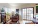 Cozy living room with seating area, window, and sliding glass door for natural light at 4998 Schumann Dr, Las Vegas, NV 89146