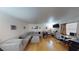 Spacious living room with a large sectional sofa, wood flooring, and natural light at 4998 Schumann Dr, Las Vegas, NV 89146