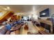 Comfortable living room with a leather sectional sofa, stone fireplace, and tile flooring at 4998 Schumann Dr, Las Vegas, NV 89146