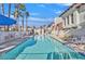 Community pool featuring lounge chairs, palm trees and a secure gated entrance at 4998 Schumann Dr, Las Vegas, NV 89146