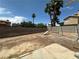 Backyard with cinder block fence, landscaping, and a swing set, perfect for outdoor activities at 5128 Sandstone Dr, Las Vegas, NV 89142