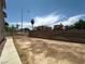Spacious backyard featuring a block wall, gate, and views of the neighborhood, perfect for outdoor activities at 5128 Sandstone Dr, Las Vegas, NV 89142