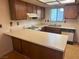Functional kitchen with wood cabinets, laminate countertops, and a gas range at 5199 Caliente St # 64, Las Vegas, NV 89119