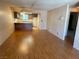Open-concept living room and kitchen featuring wood-look floors at 5199 Caliente St # 64, Las Vegas, NV 89119