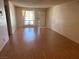 Bright living room featuring wood-look floors and a door leading to the outside at 5199 Caliente St # 64, Las Vegas, NV 89119