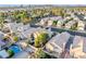 Aerial view showcasing the neighborhood with houses, city skyline, and green trees at 5332 Desert Blossom Rd, Las Vegas, NV 89107