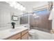 Bright bathroom with a combination tub and shower, vanity with black hardware, and natural light at 5332 Desert Blossom Rd, Las Vegas, NV 89107