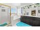 Bright bathroom with a glass enclosed shower, soaking tub, vanity with dark hardware, and natural light at 5332 Desert Blossom Rd, Las Vegas, NV 89107