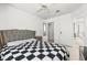 Bedroom featuring light wood floors, a ceiling fan, and a decorative black and white bedspread at 5332 Desert Blossom Rd, Las Vegas, NV 89107