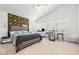 Bedroom featuring light wood floors, a ceiling fan, and an elegant gold-patterned accent wall at 5332 Desert Blossom Rd, Las Vegas, NV 89107