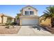 Inviting two-story home with a classic design, well-kept front yard, and a two-car garage at 5332 Desert Blossom Rd, Las Vegas, NV 89107