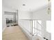 Hallway with wood floors, white railings and walls, and decorative light fixture at 5332 Desert Blossom Rd, Las Vegas, NV 89107