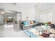 Airy living room with marble floors, a comfortable gray sofa, and lots of natural light at 5332 Desert Blossom Rd, Las Vegas, NV 89107