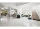 Bright living room with marble floors, open layout, and a staircase to the upper level at 5332 Desert Blossom Rd, Las Vegas, NV 89107