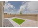 Cozy backyard featuring a small patch of artificial turf and a block wall for privacy at 5927 Coja St, Las Vegas, NV 89113
