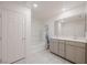 Bright bathroom featuring dual sinks, a large mirror, and a shower-tub combo at 5927 Coja St, Las Vegas, NV 89113