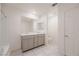 Bathroom featuring double sinks, generous counter space, and tile floors for easy maintenance at 5927 Coja St, Las Vegas, NV 89113