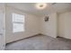 A bright bedroom has neutral carpeting, a window, and closet at 5927 Coja St, Las Vegas, NV 89113