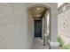 Inviting front door under an arched portico, framed by decorative columns and textured walls at 5927 Coja St, Las Vegas, NV 89113