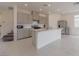 A modern kitchen with an island, stainless steel appliances, and neutral-colored cabinets at 5927 Coja St, Las Vegas, NV 89113