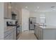 Modern kitchen with gray cabinetry, stainless steel appliances, and a large center island at 5927 Coja St, Las Vegas, NV 89113