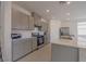 Modern kitchen features gray cabinets, stainless steel appliances, and a large island counter at 5927 Coja St, Las Vegas, NV 89113