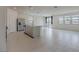 Bright, open-concept living space with tile flooring, stainless steel appliances, and a sliding glass door at 5927 Coja St, Las Vegas, NV 89113