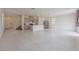 A bright, open-concept living room and kitchen area featuring tile floors and neutral tones at 5927 Coja St, Las Vegas, NV 89113
