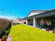 Backyard featuring artificial grass, a covered patio, and an outdoor seating area at 6021 Vivanco St, North Las Vegas, NV 89081