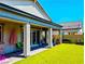A relaxing covered patio extends to a lush, well-manicured backyard with artificial turf at 6021 Vivanco St, North Las Vegas, NV 89081