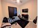Bedroom featuring a TV, a ceiling fan with color-changing lights, and a guitar in the corner at 6021 Vivanco St, North Las Vegas, NV 89081