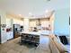 Spacious kitchen boasts a large island with barstool seating and stainless steel appliances at 6021 Vivanco St, North Las Vegas, NV 89081