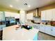 Bright kitchen featuring white cabinets, stainless steel appliances, and a large center island at 6021 Vivanco St, North Las Vegas, NV 89081