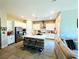 Open-concept kitchen with white cabinets, stainless steel appliances, and a center island with bar stool seating at 6021 Vivanco St, North Las Vegas, NV 89081