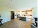 Spacious open-concept kitchen with white cabinets, stainless steel appliances, and a large center island at 6021 Vivanco St, North Las Vegas, NV 89081