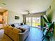 Cozy living room with comfortable seating, a ceiling fan, and sliding glass doors leading to the backyard at 6021 Vivanco St, North Las Vegas, NV 89081