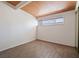 Bright bedroom features a striking wood plank ceiling, neutral walls, and horizontal window for natural light at 6112 Fairwood Cir, Las Vegas, NV 89107