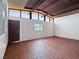 Spacious bonus room with brick flooring and a large window, ideal for various uses at 6112 Fairwood Cir, Las Vegas, NV 89107