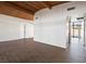 Open living room space with tile flooring, white walls, and access to outdoor pool area at 6112 Fairwood Cir, Las Vegas, NV 89107