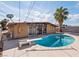 Mid-century home backyard featuring a diving board over a sparkling blue kidney-shaped pool at 6112 Fairwood Cir, Las Vegas, NV 89107