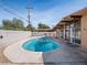 Inviting backyard pool area featuring a concrete patio and stylish house with lots of windows at 6112 Fairwood Cir, Las Vegas, NV 89107