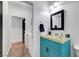 Bright bathroom boasts a turquoise vanity with stylish hardware and a framed mirror at 6170 E Sahara Ave # 1061, Las Vegas, NV 89142