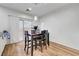 Modern dining area featuring wood floors, table with four chairs, and sliding glass doors at 6170 E Sahara Ave # 1061, Las Vegas, NV 89142