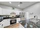 Modern kitchen featuring stainless steel appliances, granite countertops, and white cabinets at 6170 E Sahara Ave # 1061, Las Vegas, NV 89142