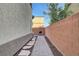 View of side yard with grill on stone and brick walkway and block wall at 6170 E Sahara Ave # 1061, Las Vegas, NV 89142
