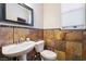 Well-lit powder room with attractive stone accent wall and modern sink at 632 Monument Point St, Henderson, NV 89002