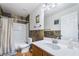 Bathroom featuring a single sink vanity with wood cabinets and a shower and tub combo at 632 Monument Point St, Henderson, NV 89002