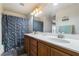 Bathroom featuring a double sink vanity with wood cabinets and a shower and tub combo at 632 Monument Point St, Henderson, NV 89002
