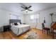 Bedroom features a ceiling fan, hardwood floors, a large bed, and lots of light at 632 Monument Point St, Henderson, NV 89002