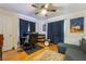 Bedroom featuring a ceiling fan, hardwood floors, drum set, and a desk at 632 Monument Point St, Henderson, NV 89002